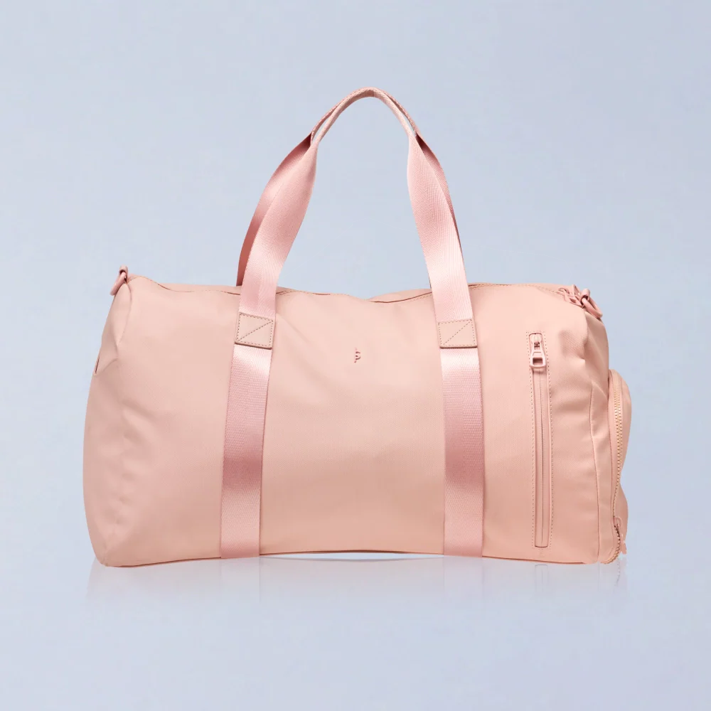 BeShapy Luxury BBL Recovery Kit  healing essentials Pink duffel bag with satin straps on a light blue background