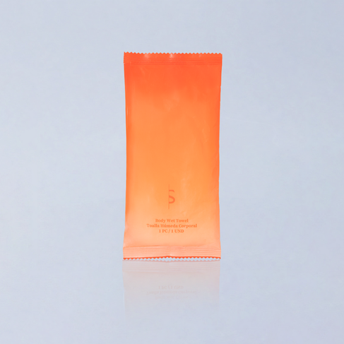 Orange tube of sunscreen on a light gray background